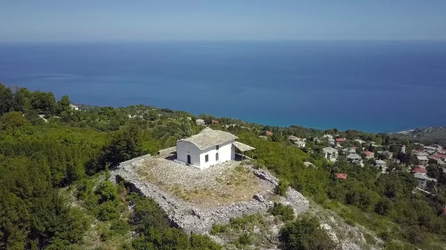 Tranquil church setting on a hilltop with ocean views and surrounding nature.